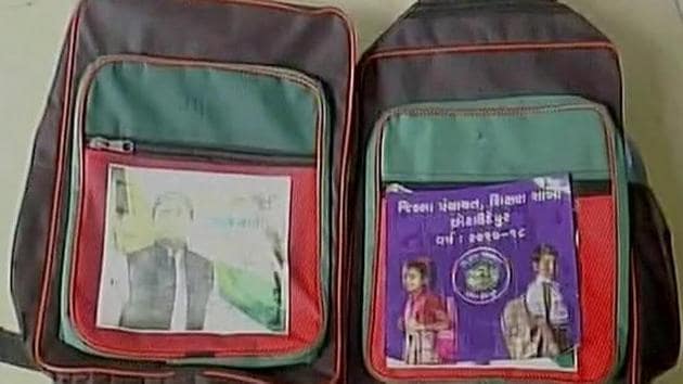 Schoolbags distributed in Gujarat had photos of Akhilesh Yadav on them. (ANI Photo) Schoolbags distributed in Gujarat had photos of Akhilesh Yadav on them. (ANI Photo)