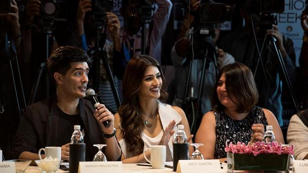 Jury members  Manish Malhotra and Kriti Sanon share a light moment during the event.  (Aalok Soni/HT Photo) 