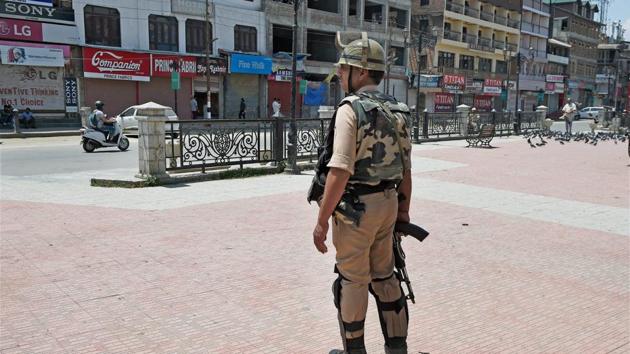 A security man stands guard at Lal Chowk in Srinagar on Tuesday. (PTI Photo) A security man stands guard at Lal Chowk in Srinagar on Tuesday. (PTI Photo)