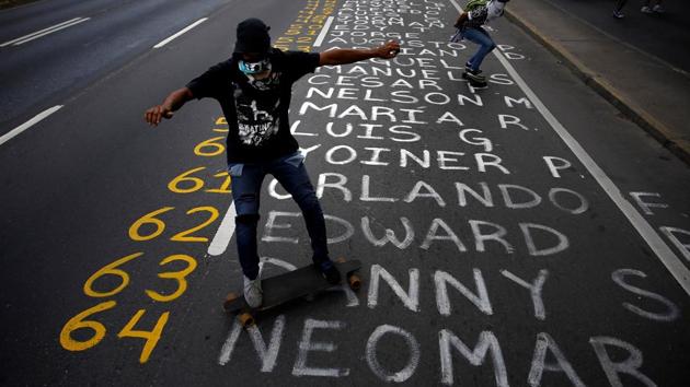 Demonstrators roll on skateboards on a list of the victims. (REUTERS)