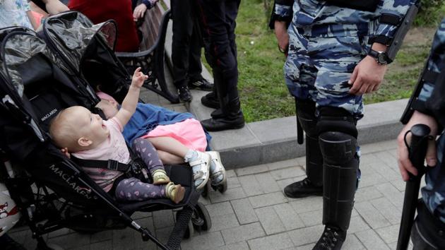 Riot police stand guard next to children in strollers during an anti-corruption protest organised by opposition leader Alexei Navalny, on Tverskaya Street in central Moscow, Russia. (Tatyana Makeyeva/REUTERS) Riot police stand guard next to children in strollers during an anti-corruption protest organised by opposition leader Alexei Navalny, on Tverskaya Street in central Moscow, Russia. (Tatyana Makeyeva/REUTERS)