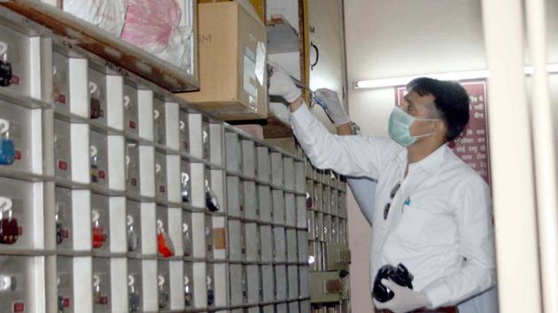 Police officials inspecting the scene of crime after thieves on Sunday night broke into the wall of Punjab National Bank branch at Modi Nagar,Ghaziabad, and escaped with valuables after breaking locks of 30 lockers.(HT Photo)