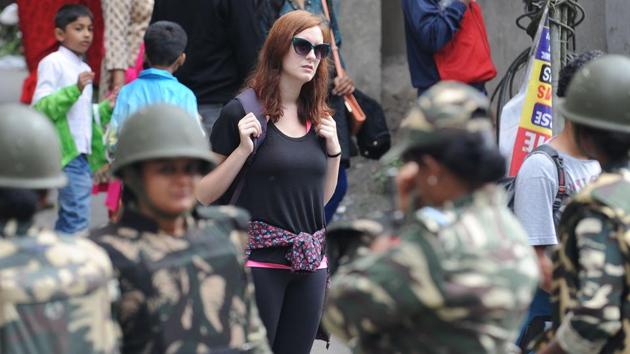 A tourist looks on as security personnel stop supporters of the GJM. Hundreds of troops and riot police patrolled the streets as panicked tourists packed their bags after local activists warned that the strike could turn violent. (AFP) A tourist looks on as security personnel stop supporters of the GJM. Hundreds of troops and riot police patrolled the streets as panicked tourists packed their bags after local activists warned that the strike could turn violent. (AFP)