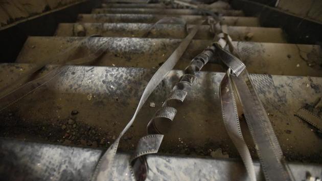 Damaged film rolls are seen lying along the staircases of the movie theatre. (Burhaan Kinu/HT PHOTO)