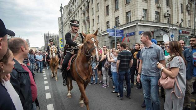 Participants in a history festival taking place on Tverskaya street ride their horses through protesters during an unauthorized opposition rally in central Moscow, Russia. The Russia Day celebrations were crashed by anti-corruption protestors immediately followed by riot police. (Mladen Antonov/AFP) Participants in a history festival taking place on Tverskaya street ride their horses through protesters during an unauthorized opposition rally in central Moscow, Russia. The Russia Day celebrations were crashed by anti-corruption protestors immediately followed by riot police. (Mladen Antonov/AFP)