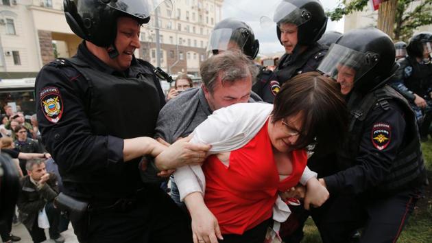 Russian police officers detain a woman at an unauthorized opposition rally in Tverskaya street in central Moscow (Maxim Zmeyev/AFP) Russian police officers detain a woman at an unauthorized opposition rally in Tverskaya street in central Moscow (Maxim Zmeyev/AFP)