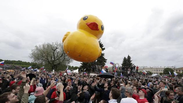 People play with a yellow duck toy, symbolizing PM Dmitry Medvedev’s luxury house for raising ducks, during an anti corruption rally in St.Petersburg, Russia. At least 300 people were arrested in St. Petersburg according to OVD-Info, an NGO that tracks arrests. (AP) People play with a yellow duck toy, symbolizing PM Dmitry Medvedev’s luxury house for raising ducks, during an anti corruption rally in St.Petersburg, Russia. At least 300 people were arrested in St. Petersburg according to OVD-Info, an NGO that tracks arrests. (AP)