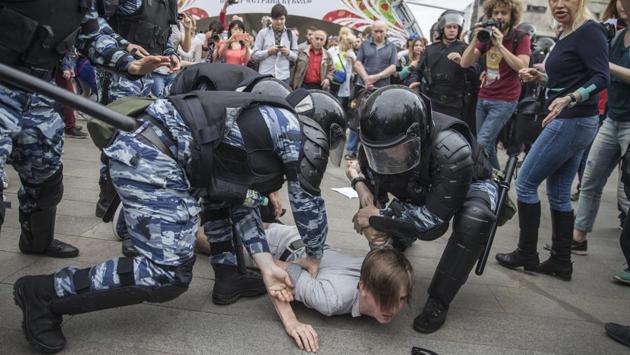 Police detain a protester at an unauthorised rally In Moscow, Russia. Demonstrating against claims of endemic corruption among officials, gatherings led by opposition leader Alexei Navalny took place in various cities across Russia. An unauthorised last minute change in the protest gathering in central Moscow to the location of a Russia Day rally resulted in the detainment of hundreds by police. (Evgeny Feldmen/AP) Police detain a protester at an unauthorised rally In Moscow, Russia. Demonstrating against claims of endemic corruption among officials, gatherings led by opposition leader Alexei Navalny took place in various cities across Russia. An unauthorised last minute change in the protest gathering in central Moscow to the location of a Russia Day rally resulted in the detainment of hundreds by police. (Evgeny Feldmen/AP)