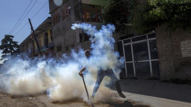 A Kashmiri protester throws a tear gas shell back at police forces during a protest in Srinagar, with parts of the valley remaining under curfew with Kashmiri separatists calling for strikes to protest the killing of a civilian by security forces last week. Police busted a Hizbul Mujahideen module when they arrested two militants in Jammu and Kashmir’s Handwara on Monday, 12th June. Two supporters of the militant outfit were also nabbed in Awantipora. (AP) A Kashmiri protester throws a tear gas shell back at police forces during a protest in Srinagar, with parts of the valley remaining under curfew with Kashmiri separatists calling for strikes to protest the killing of a civilian by security forces last week. Police busted a Hizbul Mujahideen module when they arrested two militants in Jammu and Kashmir’s Handwara on Monday, 12th June. Two supporters of the militant outfit were also nabbed in Awantipora. (AP)