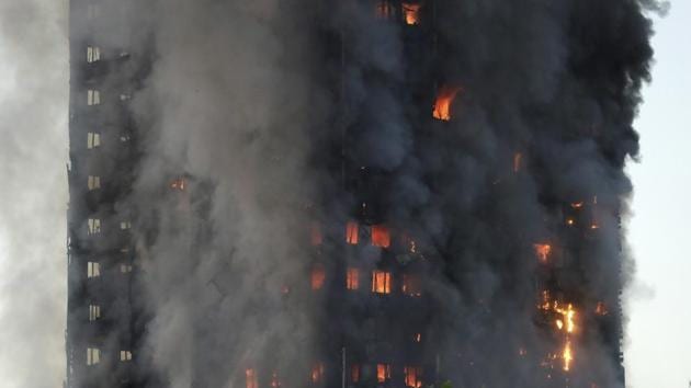 Flames and smoke billow as firefighters deal with a serious fire in a tower block at Latimer Road in West London on Wednesday.(AP Photo)