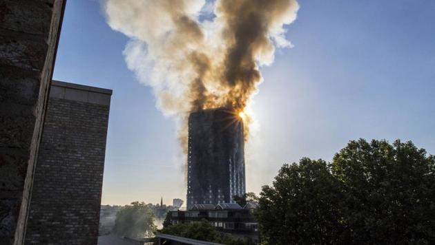 Smoke billows from a high-rise apartment building in west London on Wednesday after a massive fire raced through the building. (AP) Smoke billows from a high-rise apartment building in west London on Wednesday after a massive fire raced through the building. (AP)