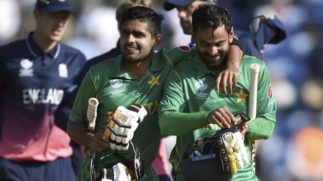 Pakistan's Babar Azam and Mohammad Hafeez celebrate victory as they leave the pitch after winning the ICC Champions Trophy semifinal vs England in Cardiff on Wednesday. Watch match video highlights of England vs Pakistan here.(AP)