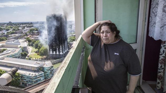 Local resident Georgina stands distraught on her balcony after a fire engulfed the 24-storey Grenfell Tower. (Rick Findler / AP)