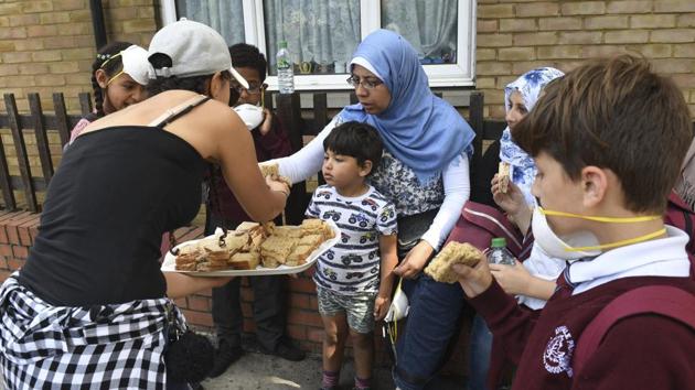 Sandwiches are handed out to local residents close to a fire that has engulfed the 24-storey Grenfell Tower in west London, Wednesday June 14, 2017. Fire swept through a high-rise apartment building in west London early Wednesday, killing an unknown number of people with around 50 people being taken to hospital. (AP Photo) Sandwiches are handed out to local residents close to a fire that has engulfed the 24-storey Grenfell Tower in west London, Wednesday June 14, 2017. Fire swept through a high-rise apartment building in west London early Wednesday, killing an unknown number of people with around 50 people being taken to hospital. (AP Photo)