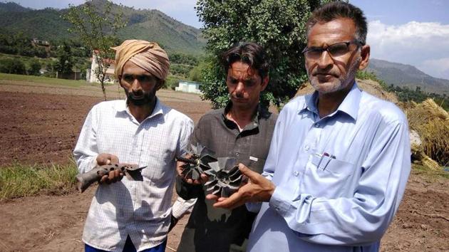 Villagers show the remains of a mortar shell fired by Pakistan at Dabzad village in Poonch district on Tuesday. (PTI Photo) Villagers show the remains of a mortar shell fired by Pakistan at Dabzad village in Poonch district on Tuesday. (PTI Photo)