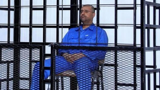 FILE PHOTO: Saif al-Islam Gaddafi, son of late Libyan leader Muammar Gaddafi, attends a hearing behind bars in a courtroom in Zintan May 25, 2014. REUTERS/Stringer/File Photo FILE PHOTO: Saif al-Islam Gaddafi, son of late Libyan leader Muammar Gaddafi, attends a hearing behind bars in a courtroom in Zintan May 25, 2014. REUTERS/Stringer/File Photo