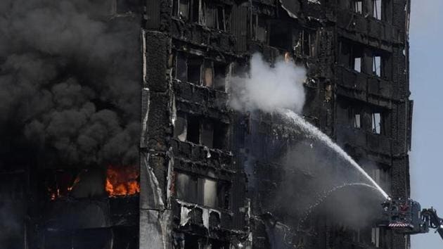 Firefighters direct jets of water onto a tower block severely damaged by a serious fire, in north Kensington, West London, Britain June 14, 2017. A fire ripped through a 24-storey block of flats in west London early on Wednesday, killing at least 17 people and trapping dozens of residents, some of whom were seen throwing children from windows in the hope they survive the blaze. (Toby Melville / Reuters)