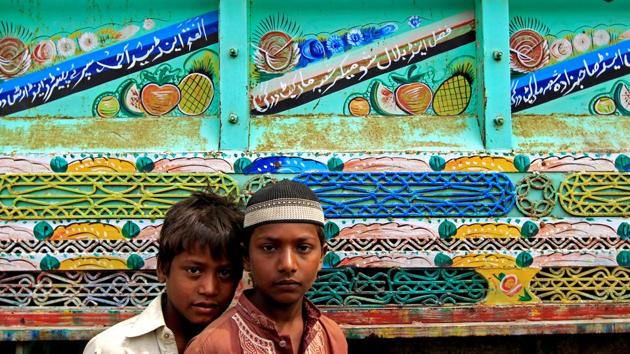 Boys pose for a picture in front of an adorned truck in Peshawar. (Caren Firouz/REUTERS)