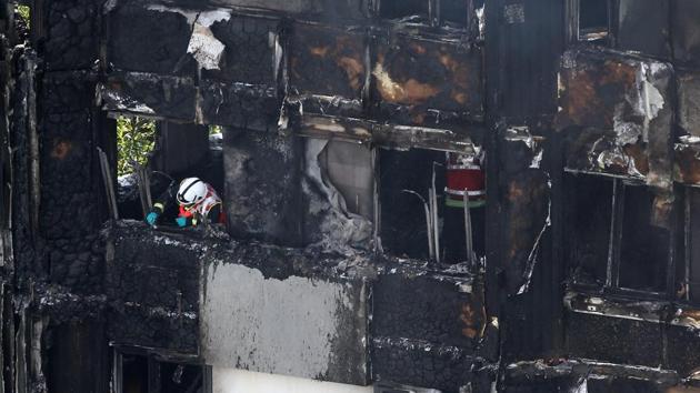 Eyewitnesses said they had also seen some people fall or jump from the Grenfell Tower, a 1970s building in the working-class north Kensington area, after it caught fire at around 1am UK time (0530 India time). (Neil Hall / REUTERS)