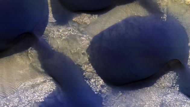 The Changing Dunes of Wirtz Crater: The large dark feature is a classic Martian sand dune.