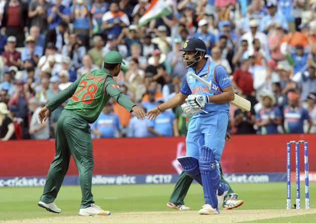 India's Rohit Sharma, right, is congratulated by Bangladesh's Tamim Iqbal after their victory. (AP) 