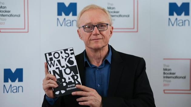 Israeli author David Grossman poses for a photograph with his book A Horse Walks Into a Bar at the shortlist photocall for the Man Booker International Prize at St James' Church in London on June 13, 2017. (Daniel Leal-Olivas/AFP) Israeli author David Grossman poses for a photograph with his book A Horse Walks Into a Bar at the shortlist photocall for the Man Booker International Prize at St James' Church in London on June 13, 2017. (Daniel Leal-Olivas/AFP)