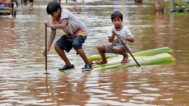 Two boys crossing a flooded street on a raft made of banana tree trunk. According to the reports, the flash floods claimed three more lives in Guwahti as the death toll rose to 4 in the capital city of Assam. More than 13,000 people have been affected so far in the four districts of Guwahti. (PTI) Two boys crossing a flooded street on a raft made of banana tree trunk. According to the reports, the flash floods claimed three more lives in Guwahti as the death toll rose to 4 in the capital city of Assam. More than 13,000 people have been affected so far in the four districts of Guwahti. (PTI)