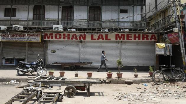 A man walks past a closed shop in Old Delhi after Chandni Chowk Sarv Vyapar Mandal called for a bandh in protest to the new taxation rules viable from next month. (Saumya Khandelwal/HT PHOTO) A man walks past a closed shop in Old Delhi after Chandni Chowk Sarv Vyapar Mandal called for a bandh in protest to the new taxation rules viable from next month. (Saumya Khandelwal/HT PHOTO)