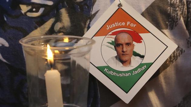 A man holds a candle as he participates in a demonstration in support of Indian naval officer Kulbhushan Jadhav in Mumbai. ICJ had ordered Pakistan not to execute Jadhav convicted of espionage and terrorism. (AP File Photo) A man holds a candle as he participates in a demonstration in support of Indian naval officer Kulbhushan Jadhav in Mumbai. ICJ had ordered Pakistan not to execute Jadhav convicted of espionage and terrorism. (AP File Photo)