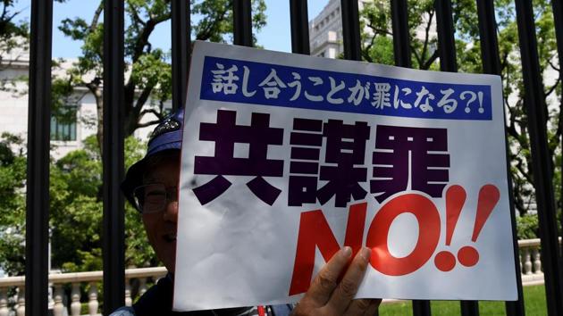 A protester holds a placard reading "No!! conspiracy bill" to protest against the controversial anti-terror law near the parliament building in Tokyo on June 15. (AFP Photo) A protester holds a placard reading "No!! conspiracy bill" to protest against the controversial anti-terror law near the parliament building in Tokyo on June 15. (AFP Photo)