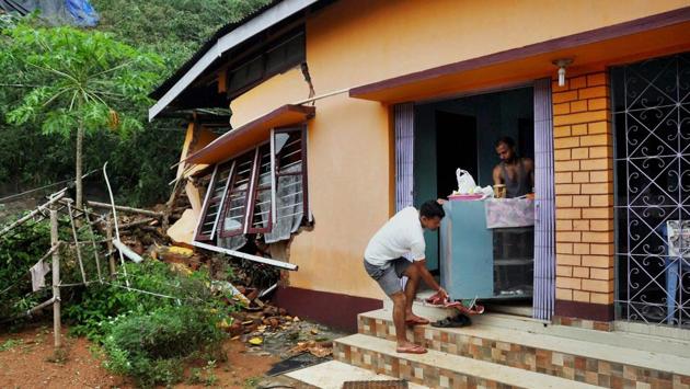 Collapsed portion of a building caused by a landslide after heavy rainfall in Japorigog. The district administration has declared Rs 4 lakh each to the families of the deceased persons, while a magisterial enquiry has been ordered to probe the deaths caused in the city. (PTI) Collapsed portion of a building caused by a landslide after heavy rainfall in Japorigog. The district administration has declared Rs 4 lakh each to the families of the deceased persons, while a magisterial enquiry has been ordered to probe the deaths caused in the city. (PTI)