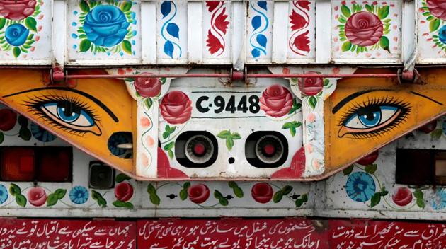 Flower motifs and eyes to ward off bad luck are seen on a decorated truck in Taxila, Pakistan. (Caren Firouz/REUTERS)