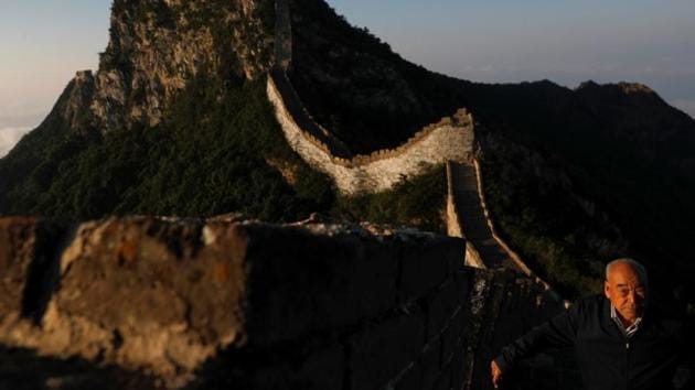 Cheng Yongmao, the engineer in charge of the reconstruction project on the Jiankou section of the Great Wall, looks as the sun rises over the wall in Beijing, China. The district government, keen to preserve the natural beauty of the Great Wall and shore up its disintegrating steps, has led intensive repairs on the Jiankou section over the past year. The restoration, which began in 2005, has been extremely slow and hindered by the uneven terrain. (Damir Sagolj/REUTERS) Cheng Yongmao, the engineer in charge of the reconstruction project on the Jiankou section of the Great Wall, looks as the sun rises over the wall in Beijing, China. The district government, keen to preserve the natural beauty of the Great Wall and shore up its disintegrating steps, has led intensive repairs on the Jiankou section over the past year. The restoration, which began in 2005, has been extremely slow and hindered by the uneven terrain. (Damir Sagolj/REUTERS)