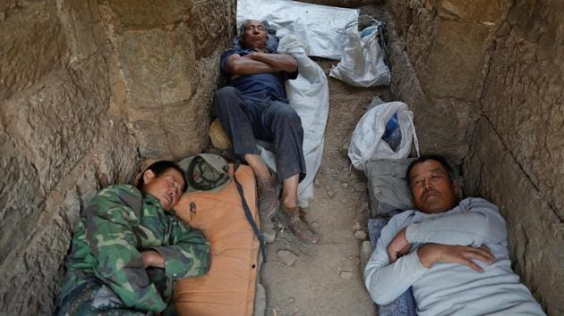 People rest after working on the reconstruction of the Great Wall. (REUTERS) People rest after working on the reconstruction of the Great Wall. (REUTERS)