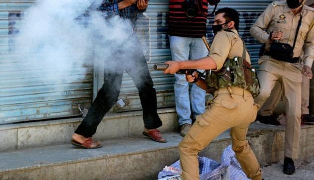 A policeman fires tear gas shells towards protesters during clashes in Srinagar. (PTI File/ Representational Photo) A policeman fires tear gas shells towards protesters during clashes in Srinagar. (PTI File/ Representational Photo)