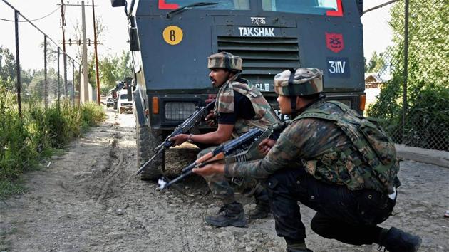 Army jawans take positions during an encounter with militants at Arwani village of Anantnag district of South Kashmir on Friday.(PTI Photo)