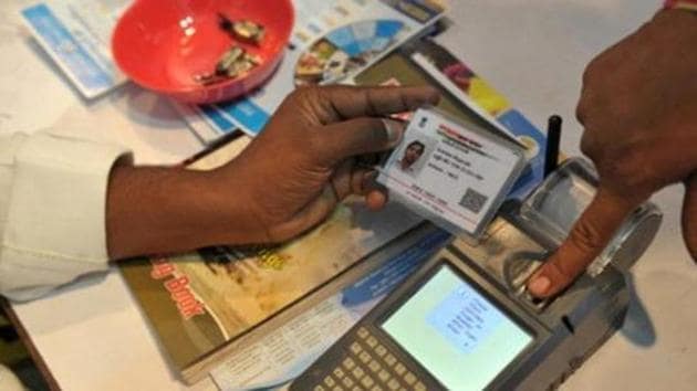 File photo of a man giving a thumb impression to withdraw money from his bank account with his Aadhaar number in Hyderabad.(AFP)