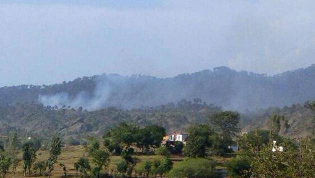 Smoke billows from the hills after shelling from Pakistan in Nowshera sector. (PTI File Photo) Smoke billows from the hills after shelling from Pakistan in Nowshera sector. (PTI File Photo)