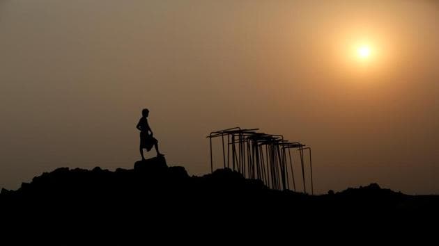 An Indian labourer is silhouetted as he works to build a bridge for the new railway in Nepal. (Navesh Chitrakar / REUTERS)