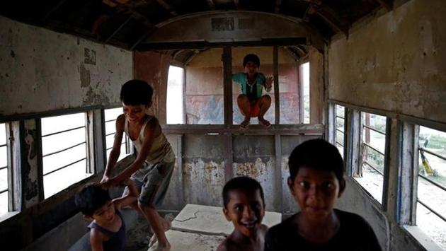 Now the only sign of life is laughing children, who chase each other through the disintegrating carriages, climbing on rusting benches and tumbling over one another. (Navesh Chitrakar / Reuters)