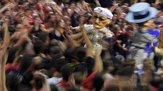 Revelers surround the ‘Nans Vells’, ‘old dwarves’ in Catalan, during the festival. (LLUIS GENE / AFP) Revelers surround the ‘Nans Vells’, ‘old dwarves’ in Catalan, during the festival. (LLUIS GENE / AFP)