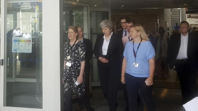Britain's Prime Minister Theresa May, centre, leaves the Chelsea and Westminster Hospital in London after visiting people who were injured in the Grenfell Tower fire. (AP Photo) Britain's Prime Minister Theresa May, centre, leaves the Chelsea and Westminster Hospital in London after visiting people who were injured in the Grenfell Tower fire. (AP Photo)