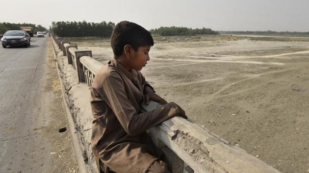The riverbed of the Yamuna resembles a desert at Ramda village near the Haryana-Uttar Pradesh border. Eighty percent of the population dependent on agriculture has lost its livelihood in the area. The drying up of the river over the last decade has forced migration to other areas in search of work, spending eight to ten months away from their homes. The river's drying up is also an ecological disaster with destruction of marine habitats. (Burhaan Kinu/HT PHOTO)