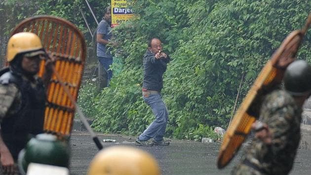 A supporter of the separatist Gorkha Janmukti Morcha fires a slingshot during clashes with security forces in Darjeeling on Saturday. (AFP) A supporter of the separatist Gorkha Janmukti Morcha fires a slingshot during clashes with security forces in Darjeeling on Saturday. (AFP)