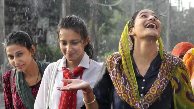 Enjoying the rain on Mall Road, Ludhiana, on Saturday, June 17. Maximum temperatures in most parts of Punjab and its neighbouring states hovered below normal levels, providing relief to the people from the heat conditions. Light rain made the day pleasant at several places. The forecast is of partly cloudy sky with possibility of rains or thundershowers during the next 48 hours. (Gurminder Singh/HT)
