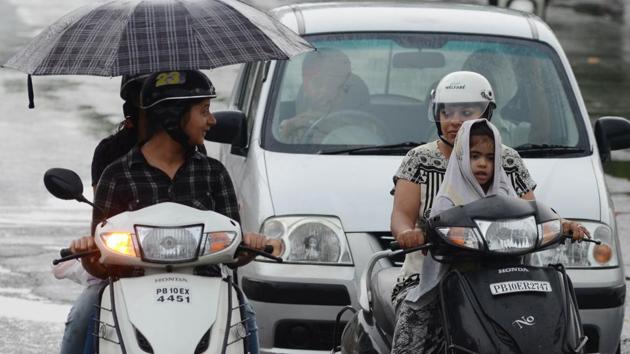 Commuters on the move despite rain in Ludhiana on Saturday, June 17. (Jagtinder Singh Grewal/HT)