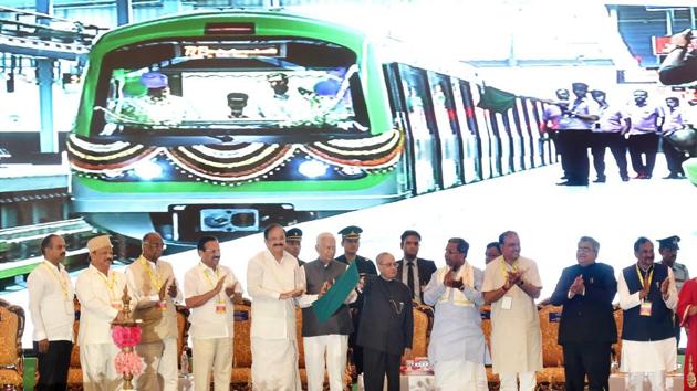 President Pranab Mukherjee flags off a train on the newly-inaugurated Green Line of Namma Metro's Phase-1, from Sampige Road Metro Station to Yelchenahalli Metro Station, in Bengaluru. Karnataka governor Vajubhai Rudabhai Vala, chief minister Siddaramaiah, and Union ministers M Venkaiah Naidu, Ananth Kumar and Sadananda Gowda are also seen. (PTI Photo) President Pranab Mukherjee flags off a train on the newly-inaugurated Green Line of Namma Metro's Phase-1, from Sampige Road Metro Station to Yelchenahalli Metro Station, in Bengaluru. Karnataka governor Vajubhai Rudabhai Vala, chief minister Siddaramaiah, and Union ministers M Venkaiah Naidu, Ananth Kumar and Sadananda Gowda are also seen. (PTI Photo)
