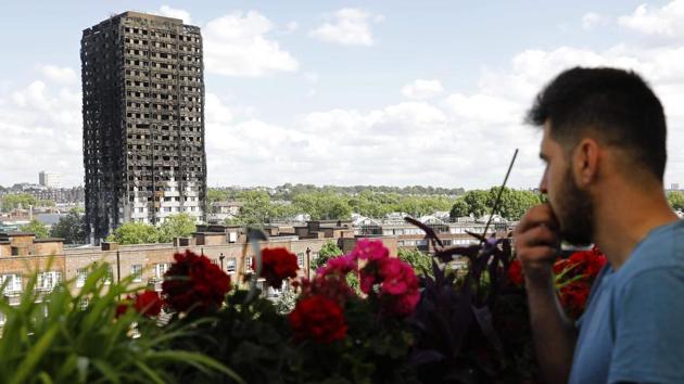 The remains of residential tower block Grenfell Tower are seen from dixon house in west London, a day after it was gutted by fire. (Tolga AKMEN/AF) The remains of residential tower block Grenfell Tower are seen from dixon house in west London, a day after it was gutted by fire. (Tolga AKMEN/AF)