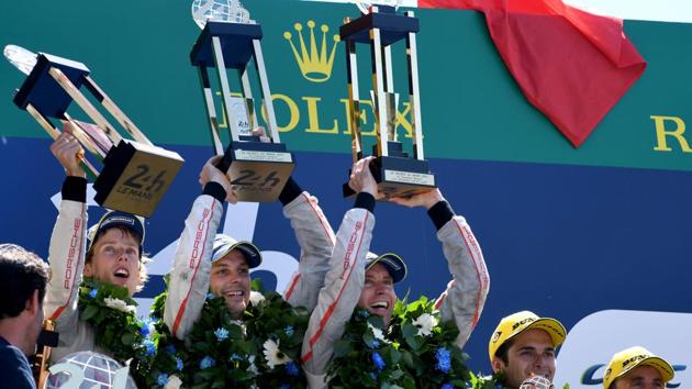 (From L to R) New Zealand's Brendon Hartley and Earl Bamber and Germany's Timo Bernhard celebrate on the podium after winning the 85th Le Mans 24-hours endurance race with their Porsche 919 Hybrid N°2 on Sunday.(AFP)