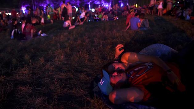 Robby Boys and Sarah Harrs embrace during the Firefly Music Festival in US. (REUTERS) Robby Boys and Sarah Harrs embrace during the Firefly Music Festival in US. (REUTERS)